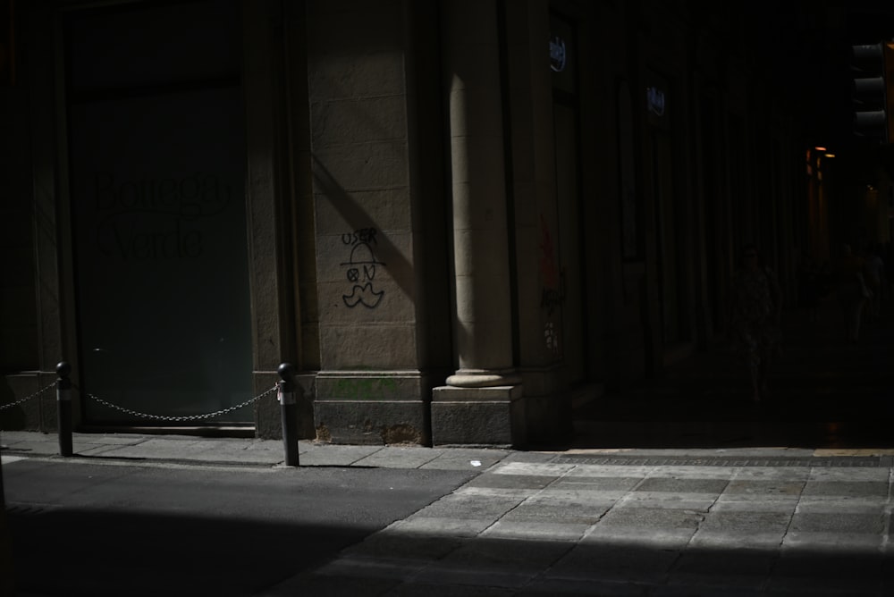 a person walking down a street at night