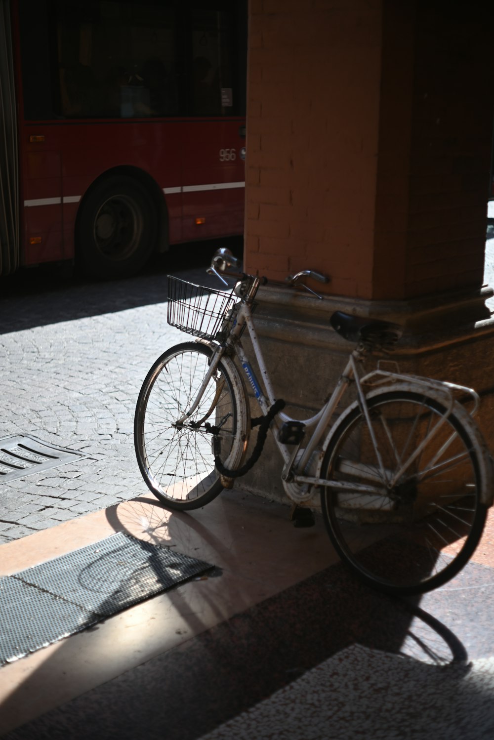 a bicycle parked next to a building on a street