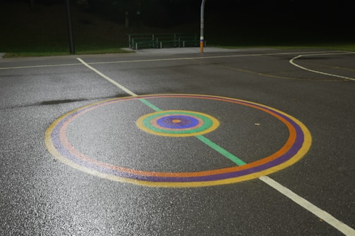 Finished outdoor sports pavement with clear waterproof coating reflecting light.