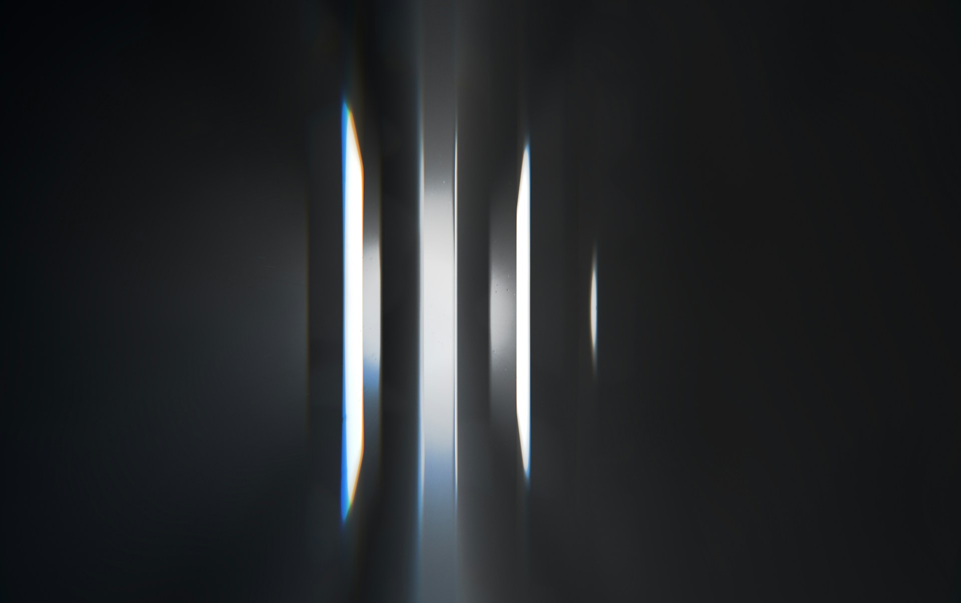 a black and white photo of light coming through a window