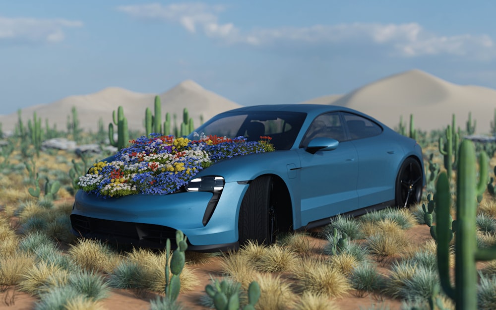 a blue car with a bunch of flowers on the hood