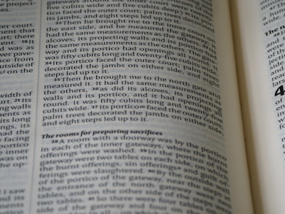 A close-up of hands flipping through a printed report.