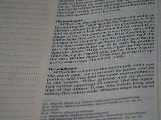 A close-up of a page from a book, showing text written in English. The layout includes a margin with dotted lines on the left and text blocks discussing architectural measurements.