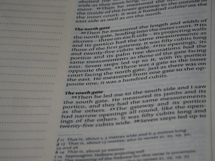 A close-up of a page from a book, showing text written in English. The layout includes a margin with dotted lines on the left and text blocks discussing architectural measurements.