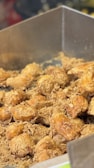 A close-up of crispy golden fried chicken fresh out of the fryer.
