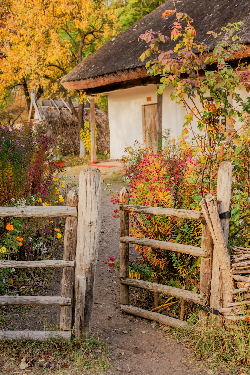 a wooden gate leading to a small house