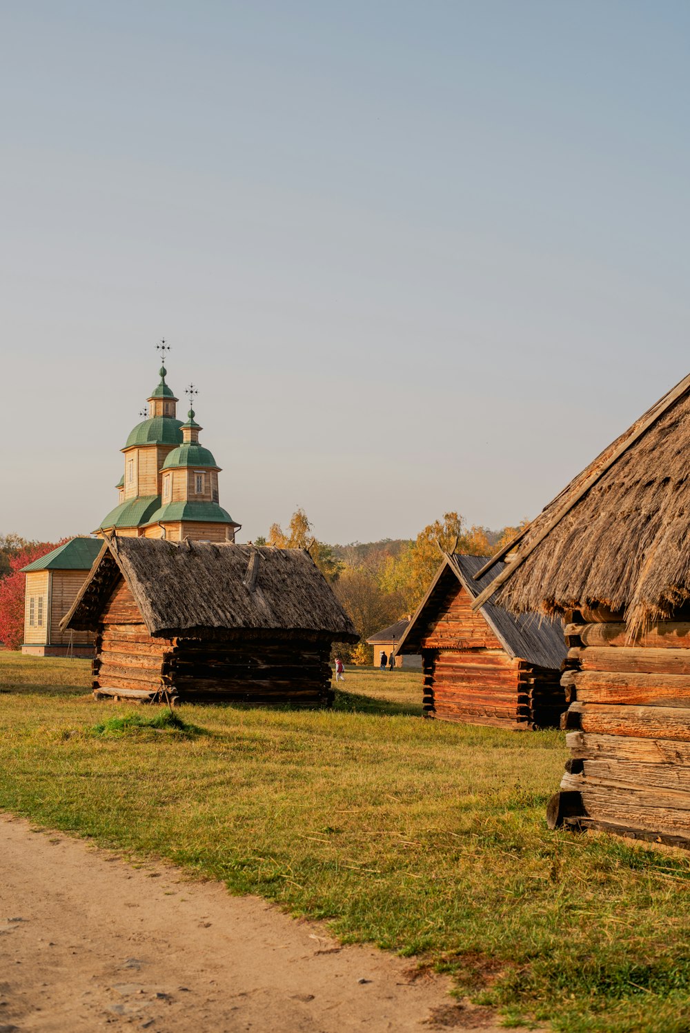 an old log cabin with a thatched roof