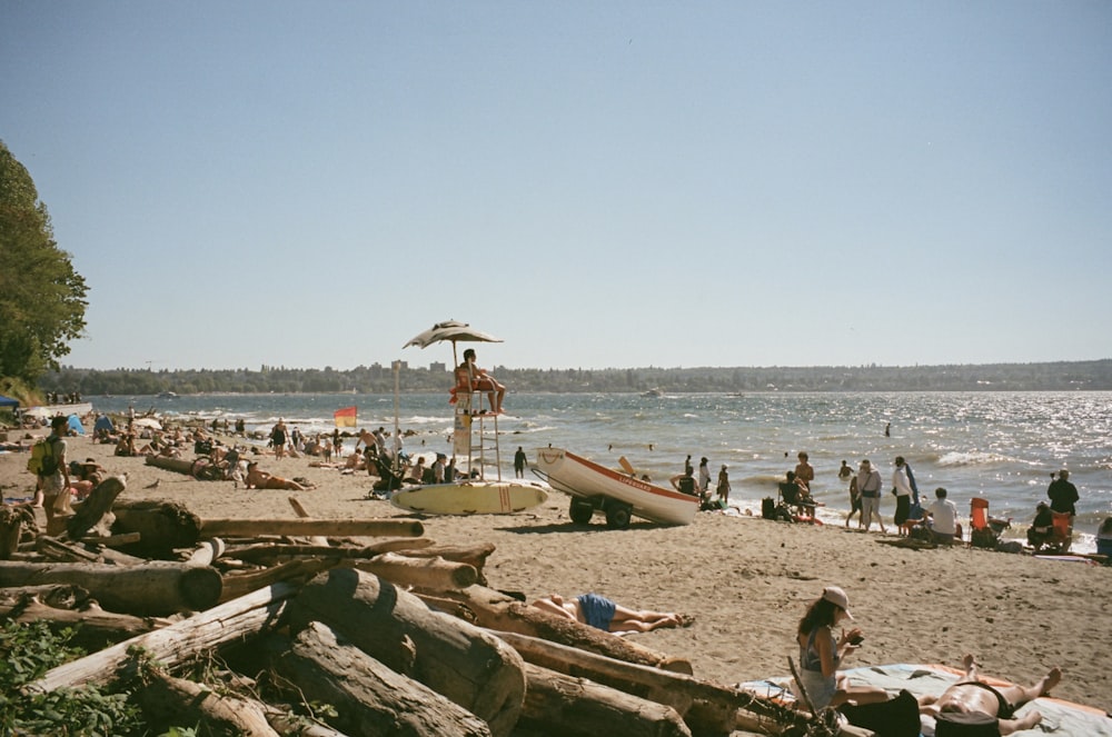 a group of people standing on top of a sandy beach