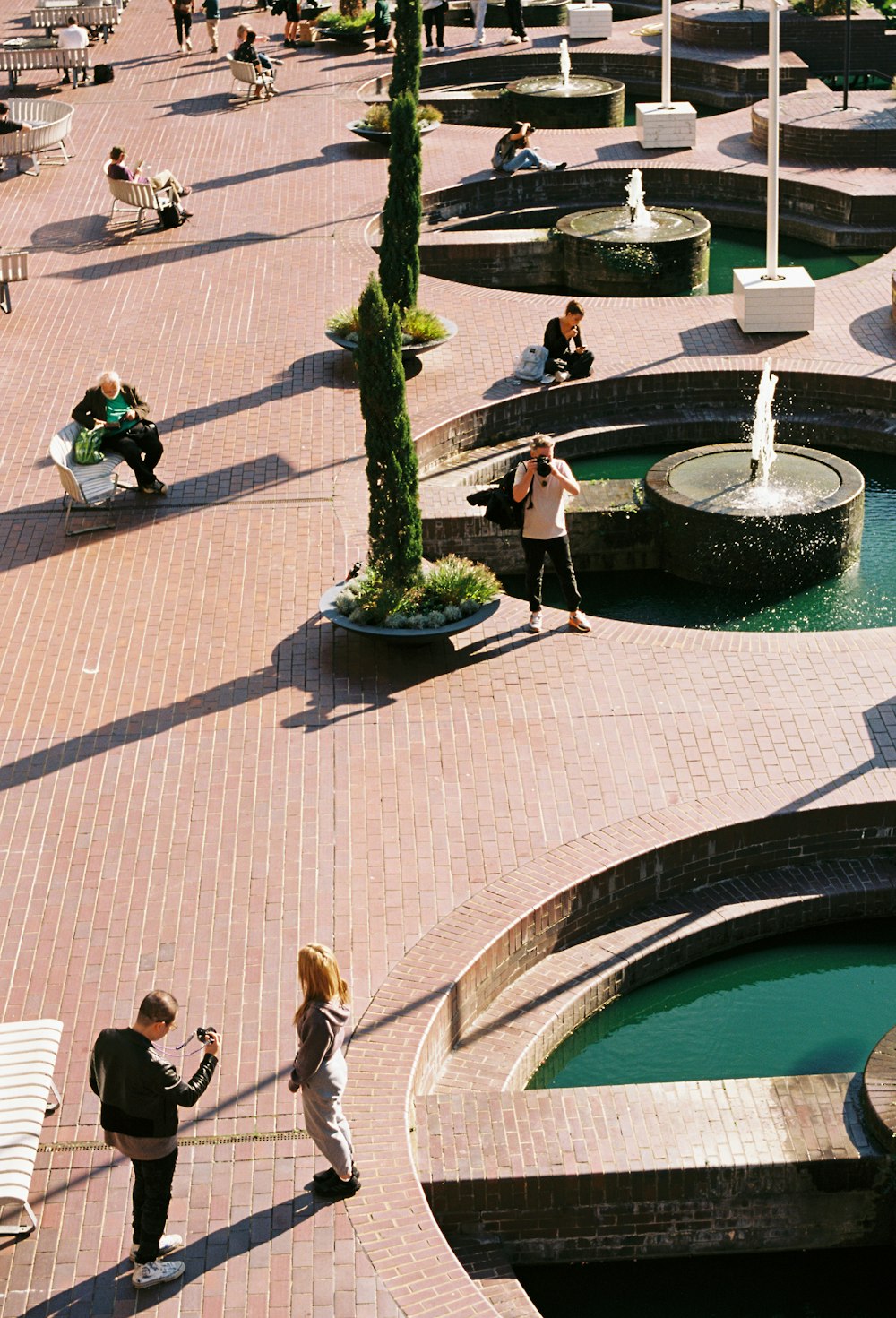 a group of people standing around a fountain