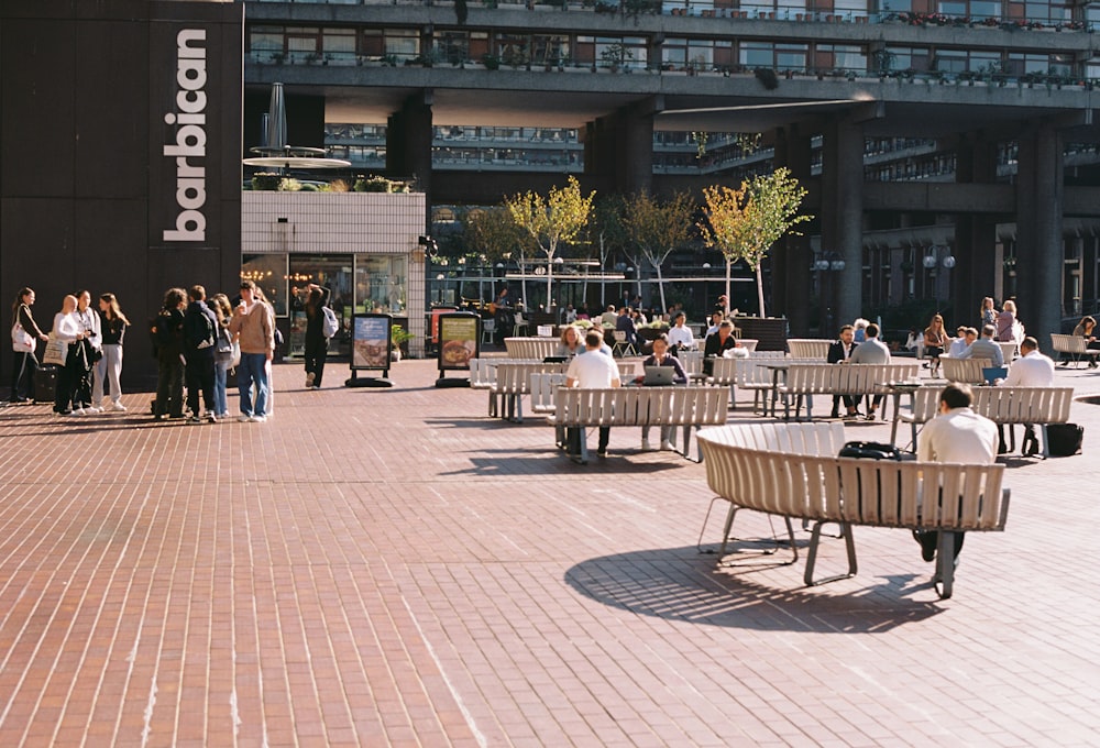 a group of people sitting on top of wooden benches