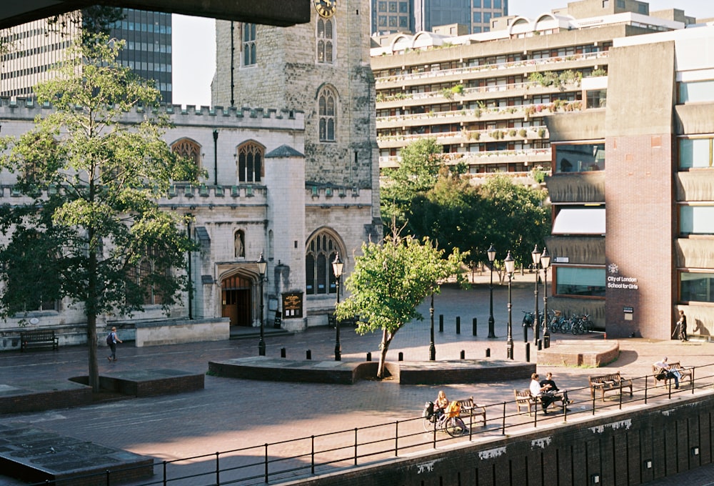 a group of people walking around a city square