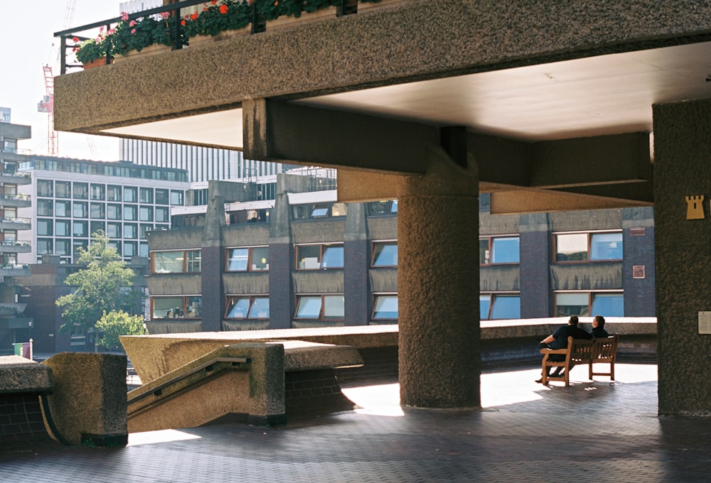 a couple of people sitting on top of a bench