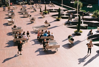 a group of people sitting on top of benches