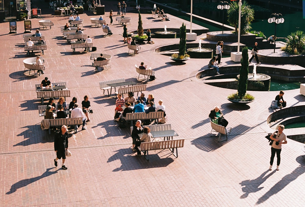 a group of people sitting on top of benches