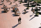 a group of people walking around a park