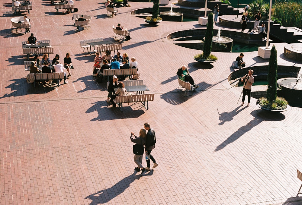 a group of people walking around a park