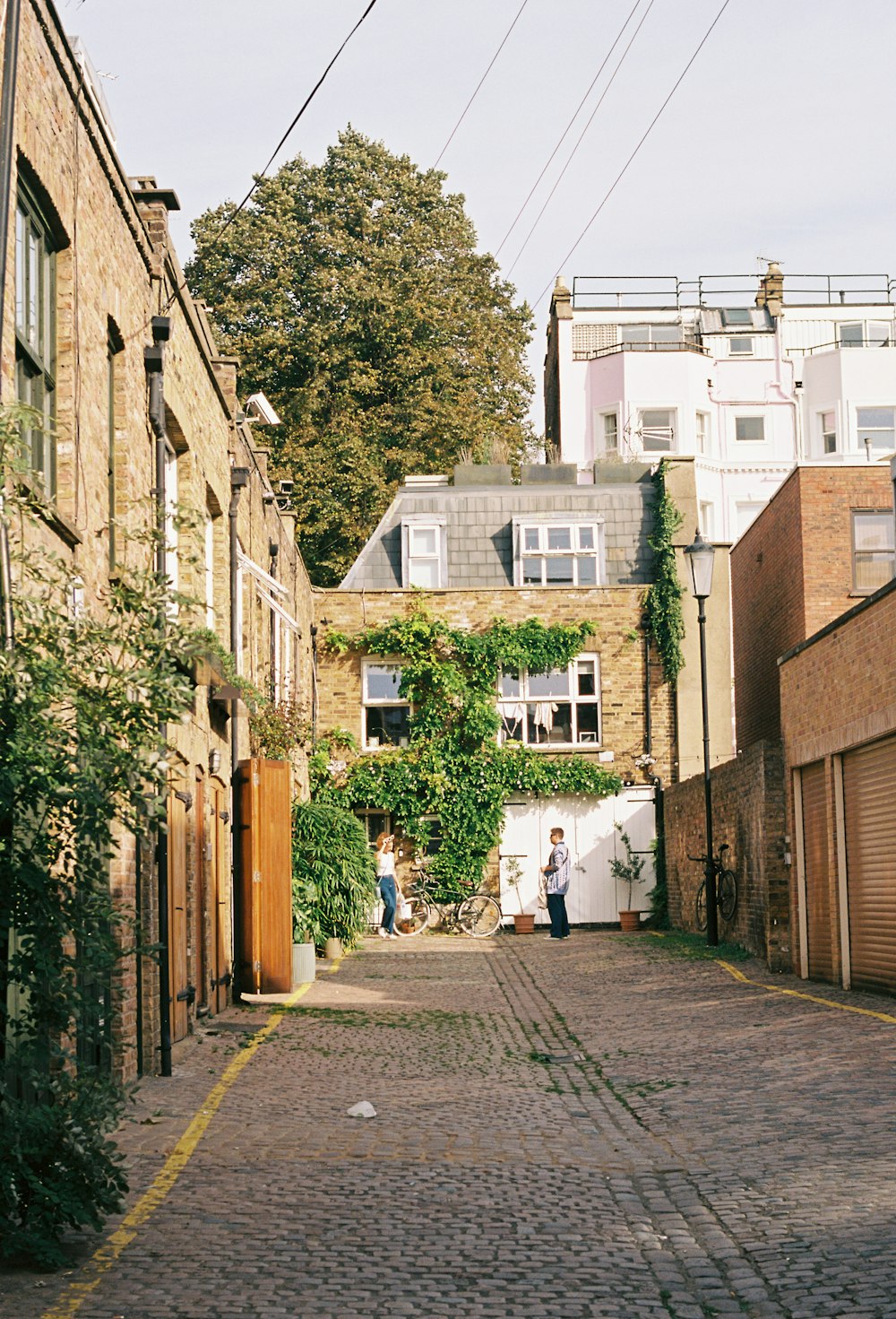 a cobblestone street lined with tall brick buildings