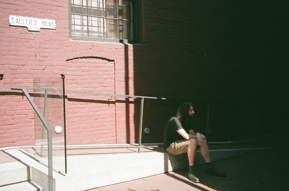 a woman sitting on the steps of a building