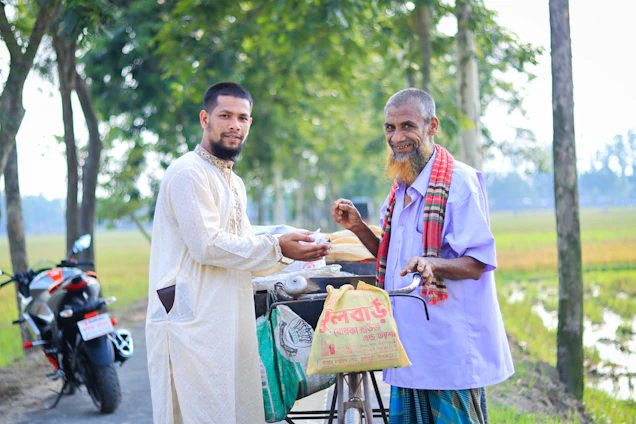 A friendly Velocetrade agent handing over cash to a happy customer with a bike in the background.