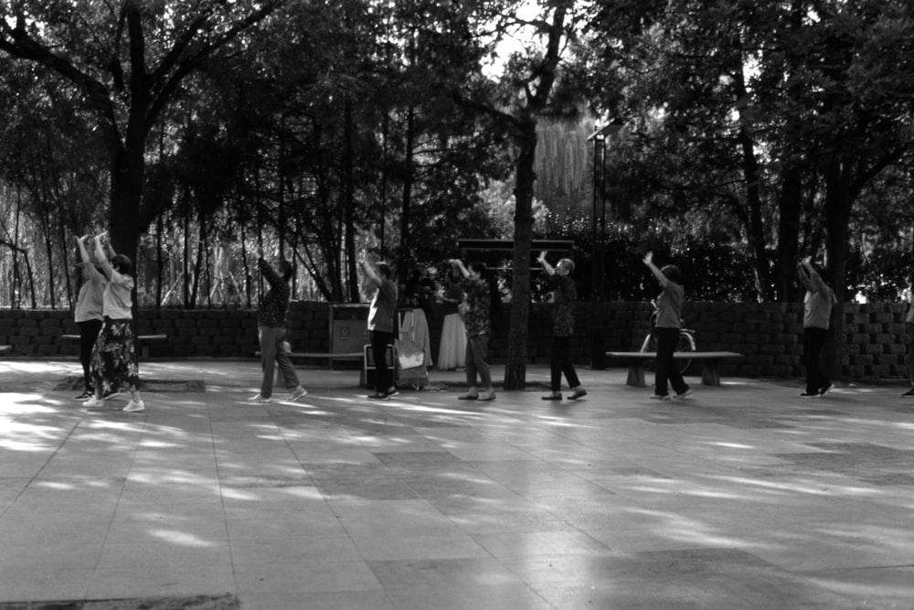 a black and white photo of a group of people in a park