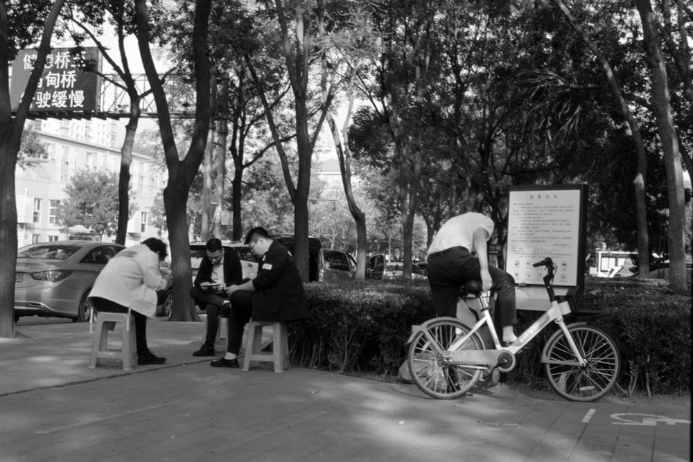 a black and white photo of people sitting on benches