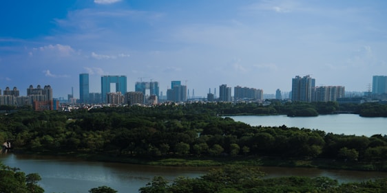 A scenic view of Hyderabad's skyline with modern buildings and lush greenery.