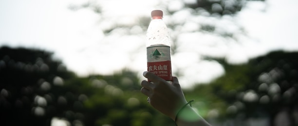 A happy customer holding a vibrant chacolab bottle outdoors.