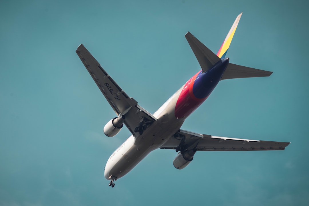 a large jetliner flying through a blue sky,