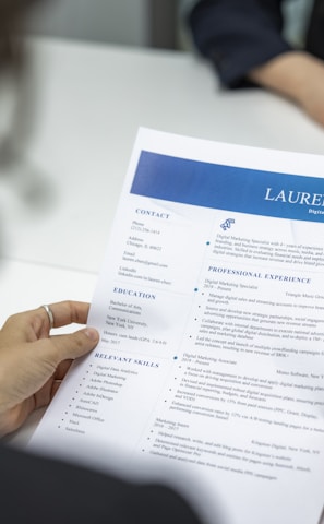 a woman is reading a resume at a table