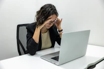 a woman sitting in front of a laptop computer