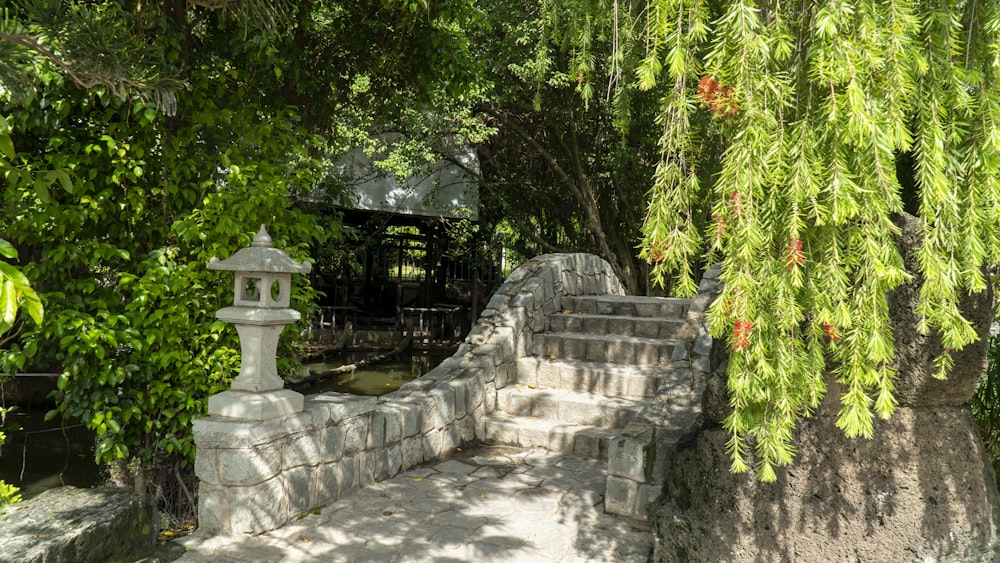 a stone wall with a lantern on top of it