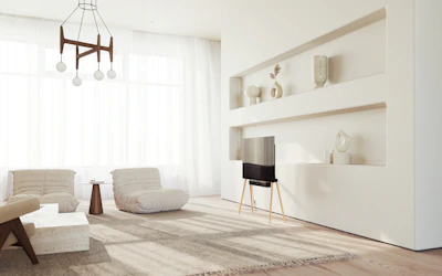 A bright, airy living room with neatly arranged shelves and minimal clutter.