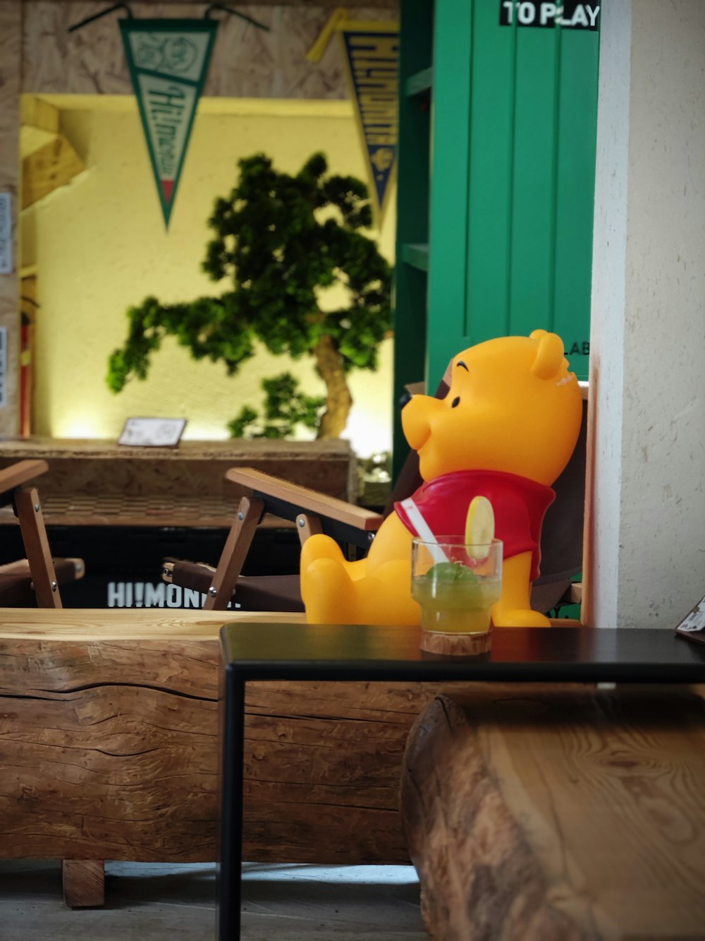 a winnie the pooh toy sitting on a table
