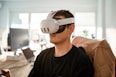 a man sitting in a chair wearing a pair of virtual glasses