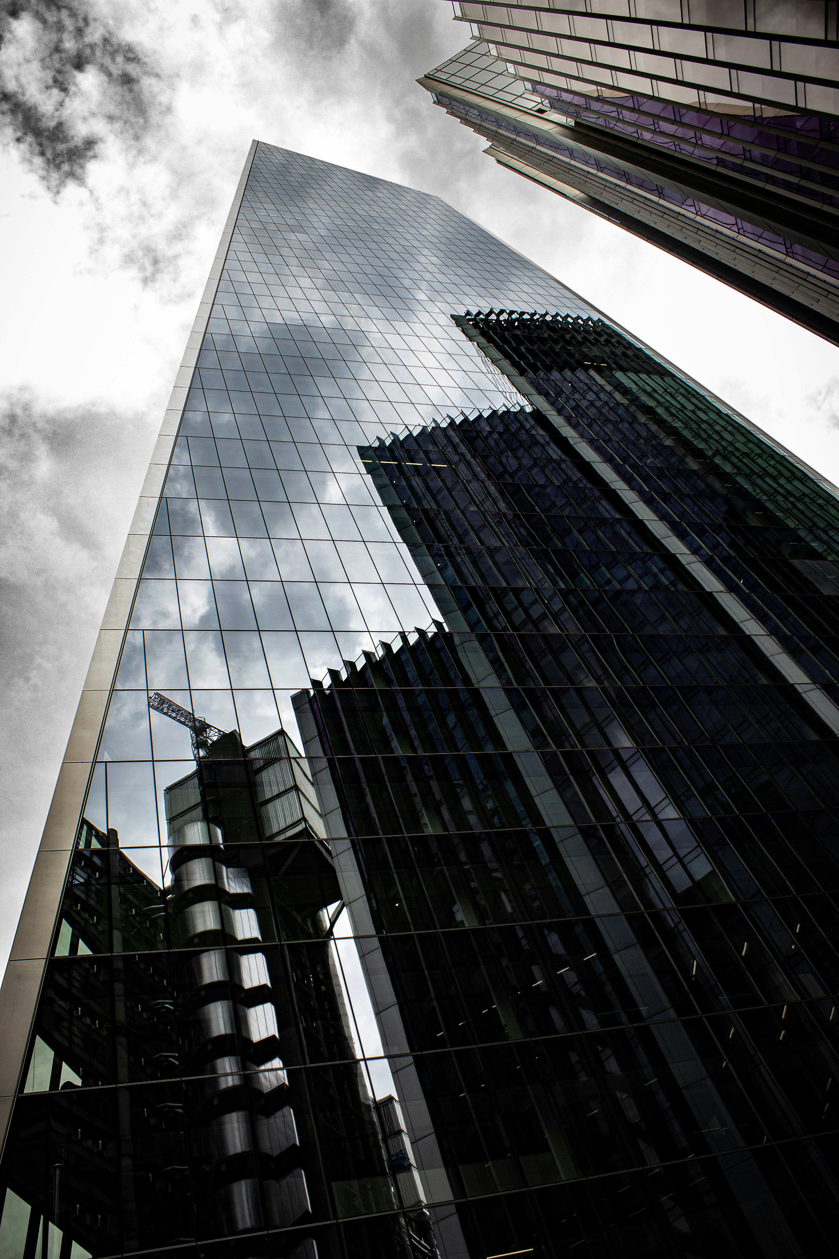 An upward view of a modern skyscraper, representing ambition and advantage.
