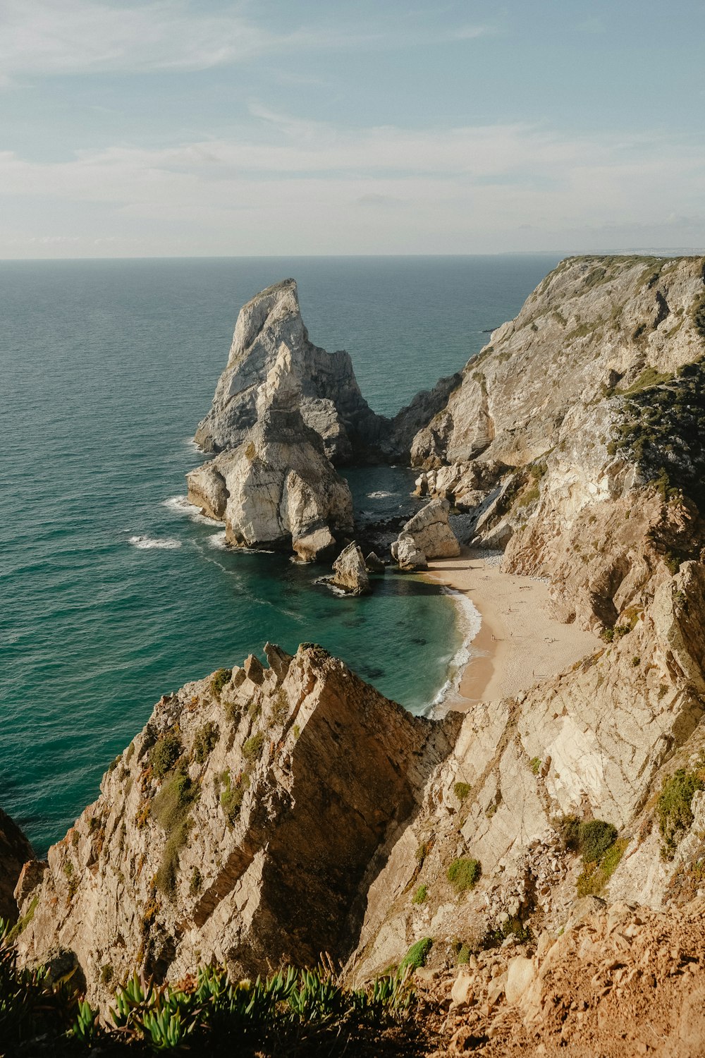 a view of the ocean from a rocky cliff