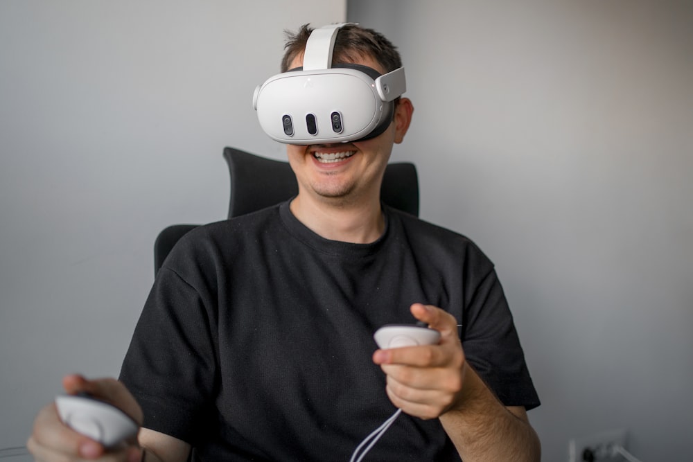 a man sitting in a chair holding a remote control