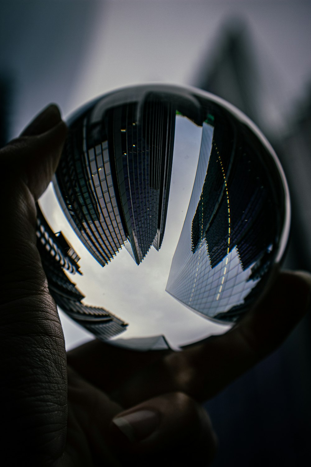 a person holding a glass ball in their hand