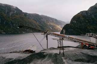 A close-up of a telescopic belt conveyor in a busy industrial warehouse.