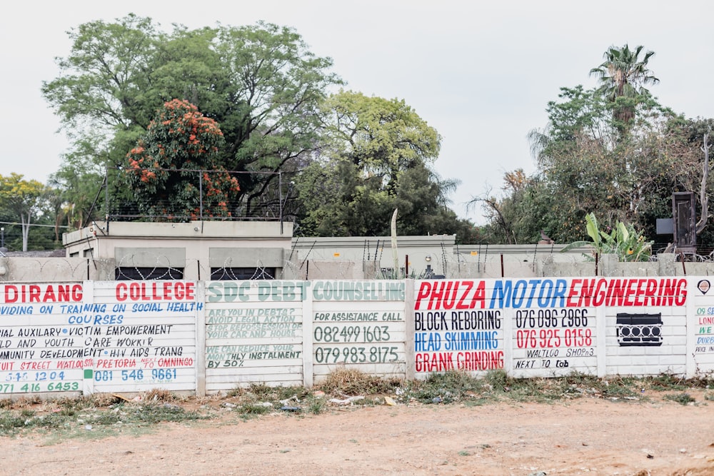 a fence with a bunch of signs on it