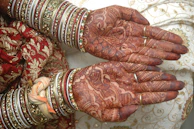 Intricate mehendi design on bride’s hands with deep, rich henna color.