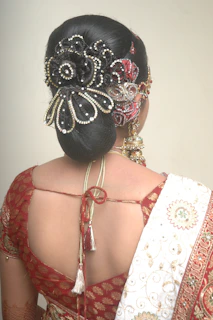 Long decorated braid styled with premium golden accessories and jasmine flowers.