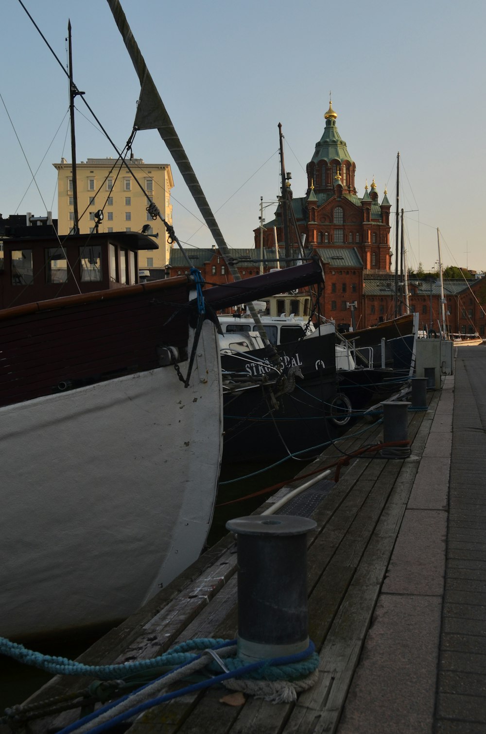 a row of boats sitting next to each other on a pier