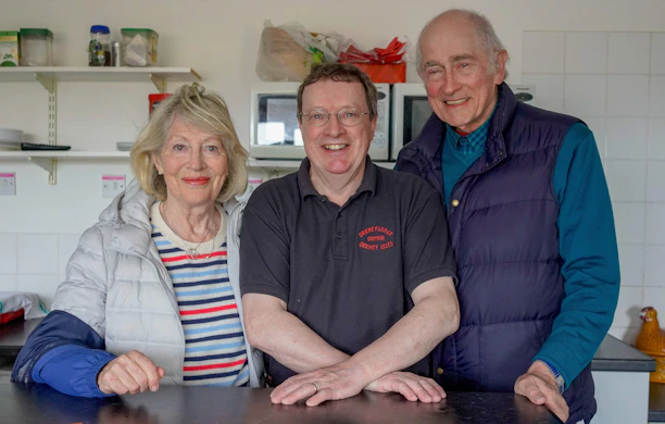 Smiling family in their kitchen, happy with the newly repaired hob stove.