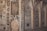Intricate decorative wall panels with floral and geometric patterns, featuring arched niches. The artwork is composed of detailed carvings and mirrored surfaces that reflect light.