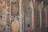 Intricate decorative wall panels with floral and geometric patterns, featuring arched niches. The artwork is composed of detailed carvings and mirrored surfaces that reflect light.