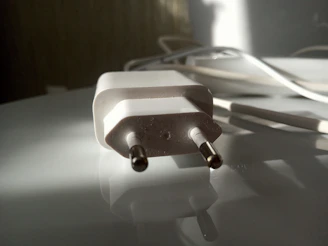 Side view of the spark plug’s double platinum tips gleaming under soft lighting.