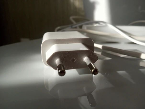 Side view of the spark plug’s double platinum tips gleaming under soft lighting.