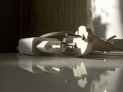 Close-up of a sleek smart plug glowing softly in a modern living room.