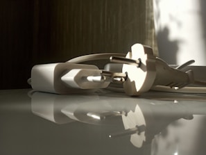 Close-up of a sleek smart plug glowing softly in a cozy living room setting